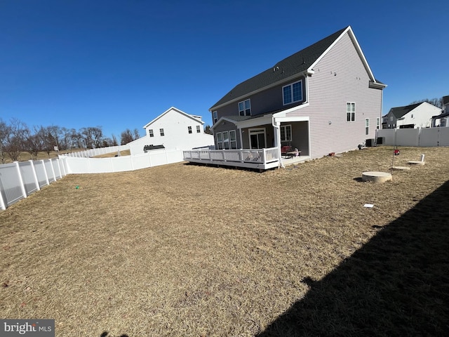 back of house featuring a wooden deck and a fenced backyard