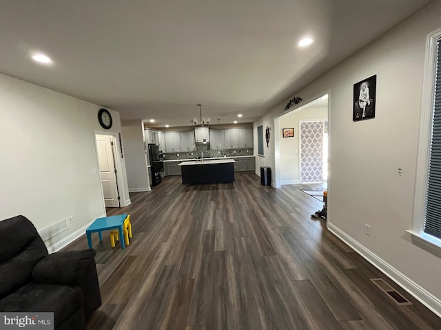 living room featuring recessed lighting, visible vents, baseboards, and dark wood finished floors