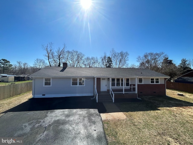 ranch-style home with a front lawn, fence, aphalt driveway, covered porch, and crawl space