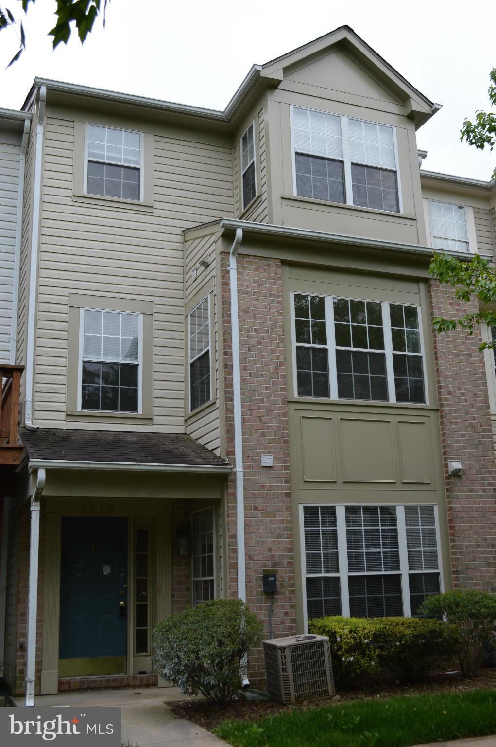 view of front of house featuring brick siding and central AC