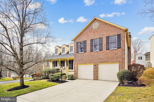 view of front of home featuring brick siding, driveway, a porch, and a garage