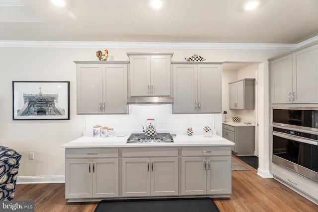 kitchen featuring gray cabinets, appliances with stainless steel finishes, and wood finished floors