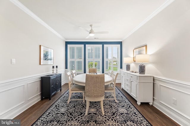 dining space featuring dark wood-style flooring, wainscoting, a ceiling fan, and ornamental molding