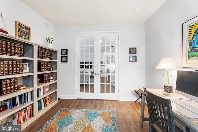 home office with french doors, baseboards, and wood finished floors