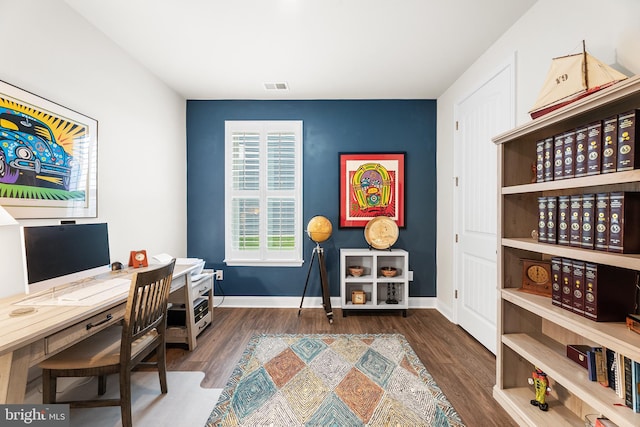 office space with visible vents, baseboards, and wood finished floors