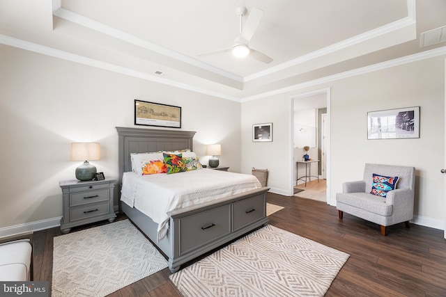 bedroom with visible vents, baseboards, a raised ceiling, and dark wood-type flooring