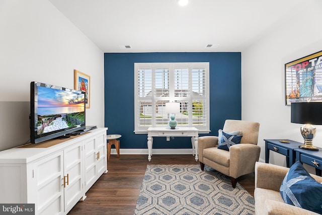 sitting room featuring visible vents, baseboards, and dark wood-type flooring