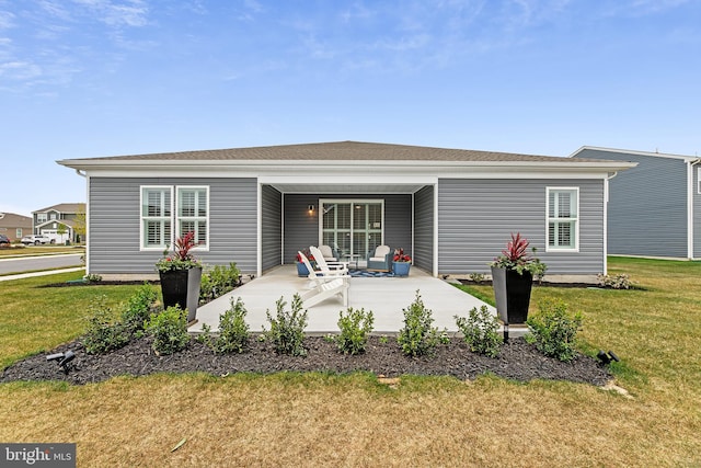 back of house featuring an attached carport, a yard, and a patio area