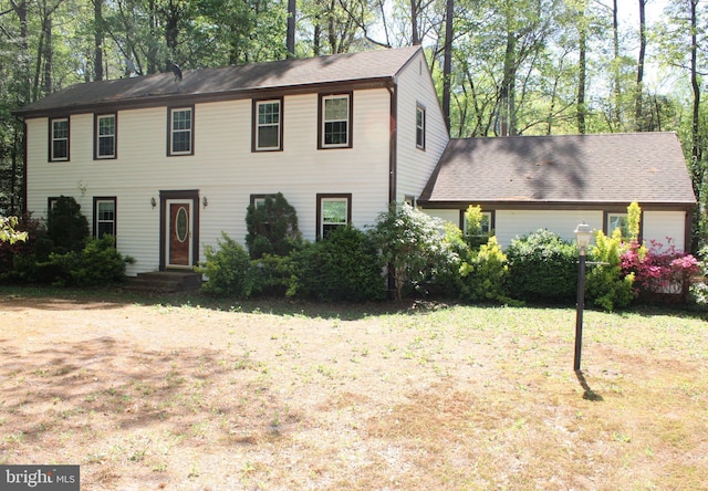 colonial home with a front yard