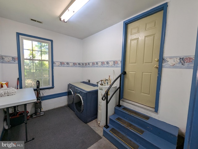 laundry area featuring laundry area, visible vents, washer and clothes dryer, and water heater