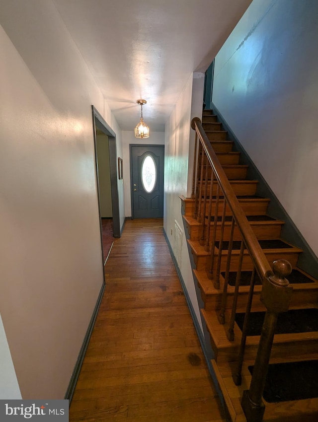 foyer featuring stairs and wood finished floors