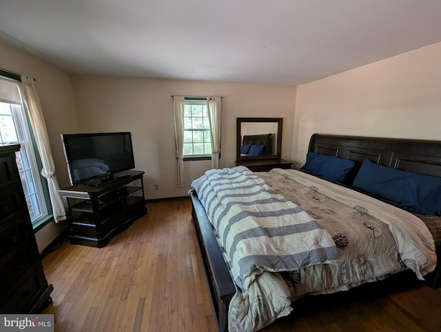bedroom with baseboards and hardwood / wood-style floors
