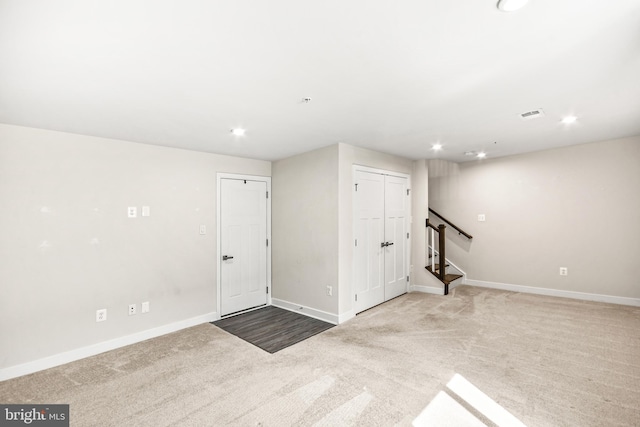 basement with visible vents, baseboards, stairway, carpet floors, and recessed lighting