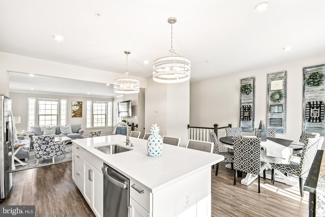 kitchen featuring a sink, dark wood finished floors, open floor plan, and stainless steel appliances