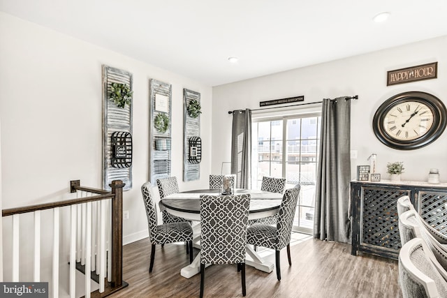 dining area with baseboards and wood finished floors