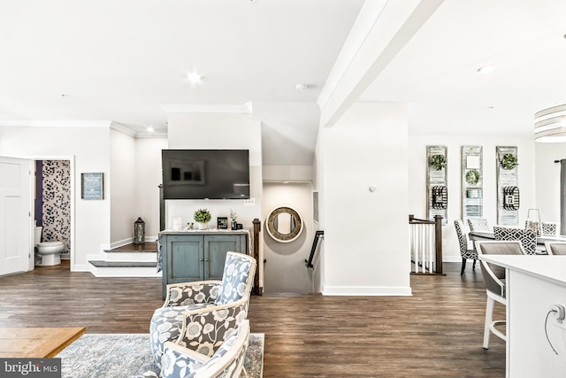 living area with dark wood finished floors, baseboards, and ornamental molding