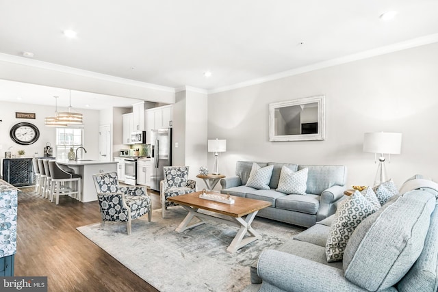 living area with dark wood-style floors, recessed lighting, and ornamental molding