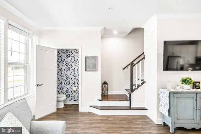 foyer entrance featuring ornamental molding, stairs, baseboards, and wood finished floors