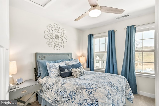 bedroom with a ceiling fan, carpet flooring, baseboards, and visible vents