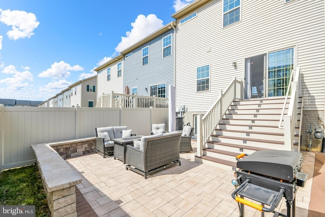 view of patio with a residential view, a grill, outdoor lounge area, and a fenced backyard