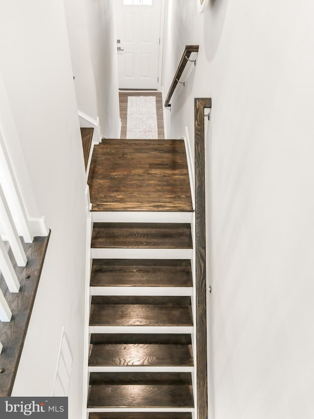 stairway with wood finished floors