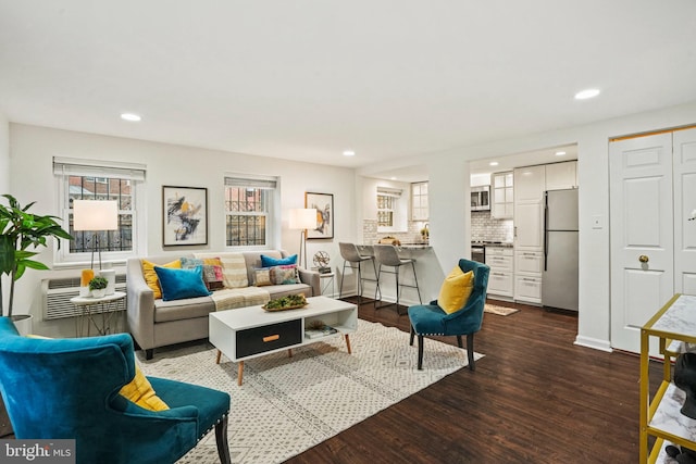 living room featuring recessed lighting, a wall mounted air conditioner, and dark wood-style flooring