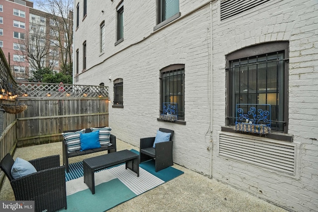 view of patio featuring an outdoor living space and fence