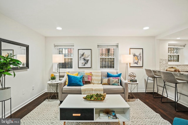 living room with recessed lighting, baseboards, and wood finished floors