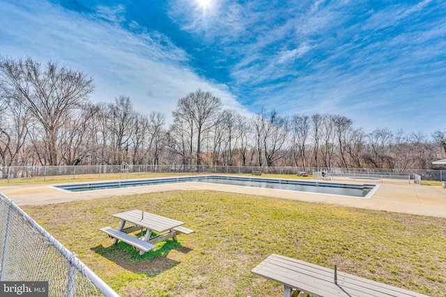 view of yard with a community pool and fence