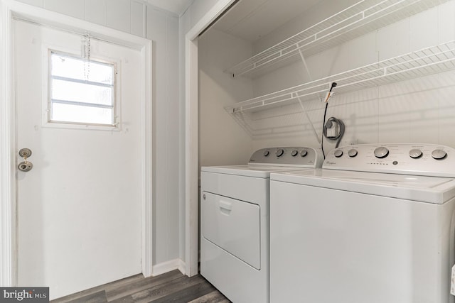 laundry room featuring dark wood-style flooring, laundry area, and washing machine and clothes dryer