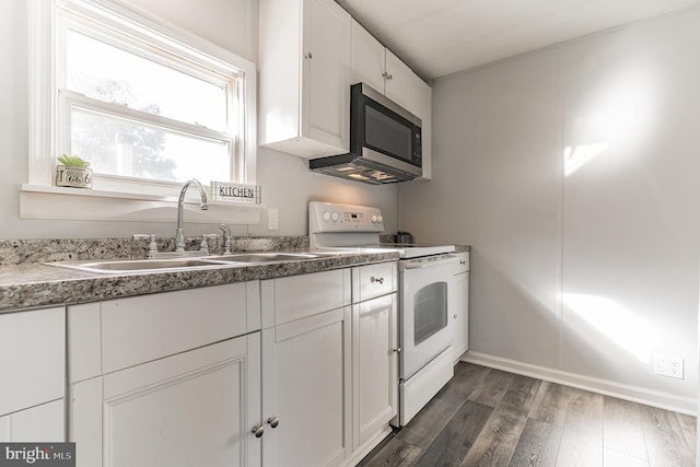 kitchen featuring white range with electric cooktop, a sink, stainless steel microwave, dark wood finished floors, and white cabinetry