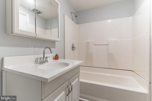 full bath featuring vanity, visible vents, and shower / bathtub combination