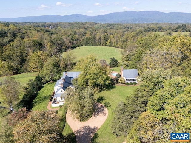 aerial view with a mountain view and a wooded view