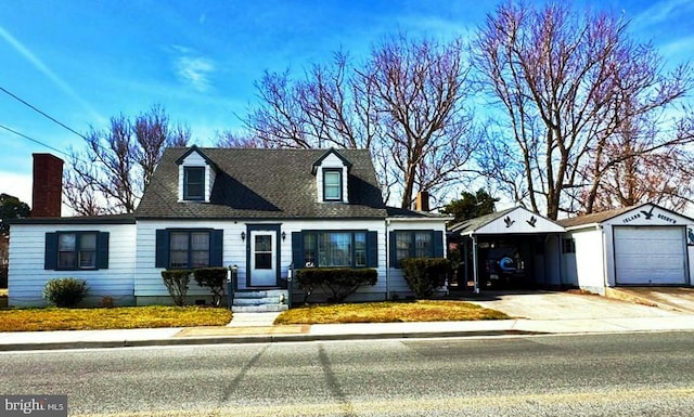 cape cod home with a garage, an outdoor structure, driveway, and a shingled roof