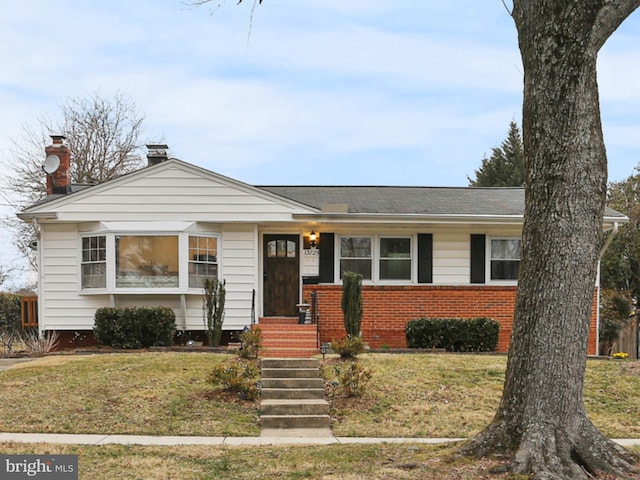 view of front of home with brick siding and a front yard