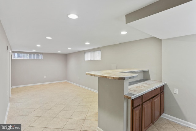 interior space featuring recessed lighting, baseboards, a bar, and light tile patterned floors