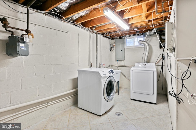 clothes washing area featuring electric panel, laundry area, and independent washer and dryer