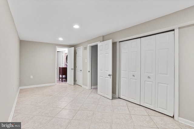 unfurnished bedroom with light tile patterned floors, recessed lighting, and baseboards