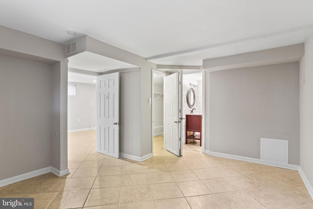 spare room with visible vents, baseboards, and light tile patterned flooring