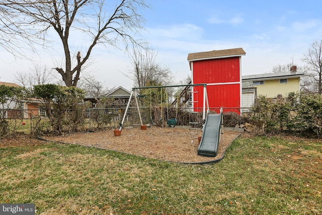 view of play area featuring a lawn and fence