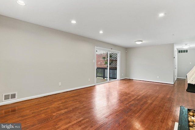 unfurnished living room with recessed lighting, visible vents, baseboards, and wood finished floors