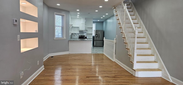 entryway with stairway, recessed lighting, wood finished floors, and baseboards