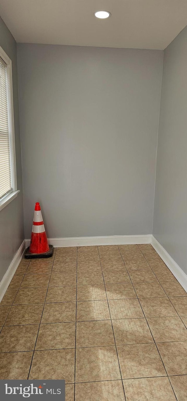 interior space with recessed lighting, baseboards, and tile patterned flooring