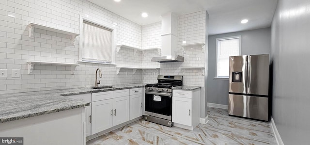 kitchen with white cabinetry, open shelves, appliances with stainless steel finishes, and a sink