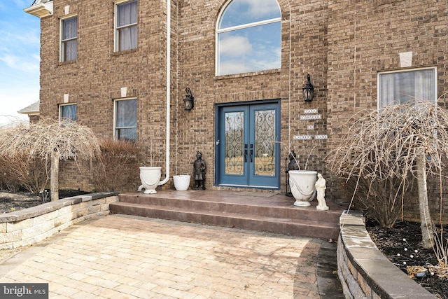 entrance to property with french doors and brick siding