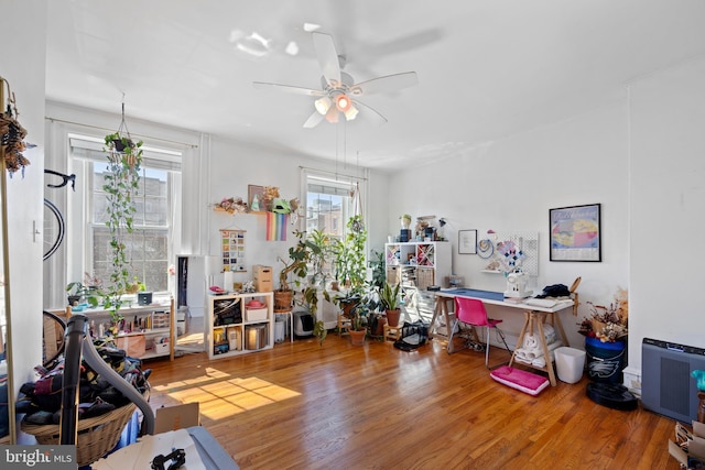 interior space with ceiling fan and wood finished floors