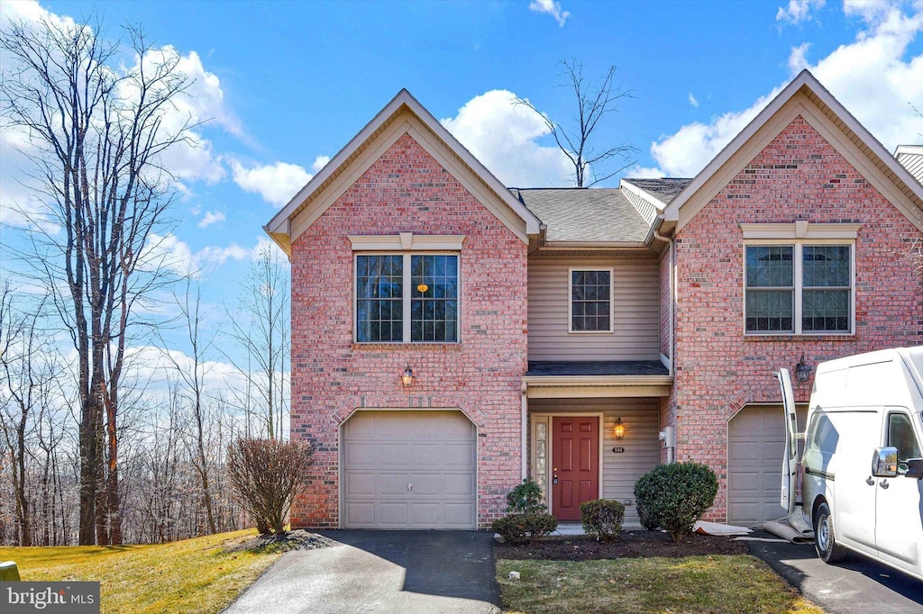 view of front of house with a garage, brick siding, driveway, and a shingled roof