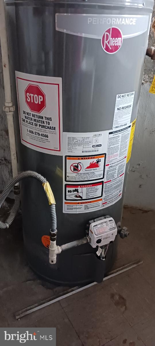 utility room featuring gas water heater