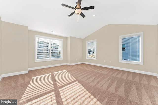 unfurnished room with vaulted ceiling, visible vents, baseboards, and carpet floors