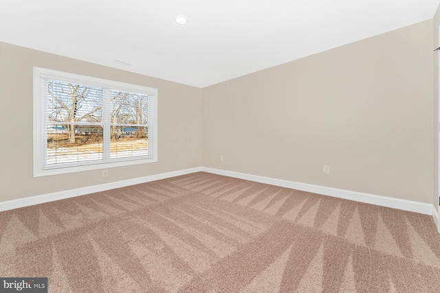 carpeted empty room featuring recessed lighting and baseboards